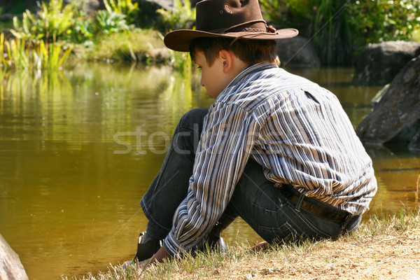 Child sitting by outback billabong Stock photo © lovleah