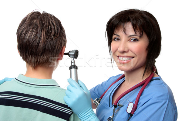 Doctor checking ears with otoscope Stock photo © lovleah