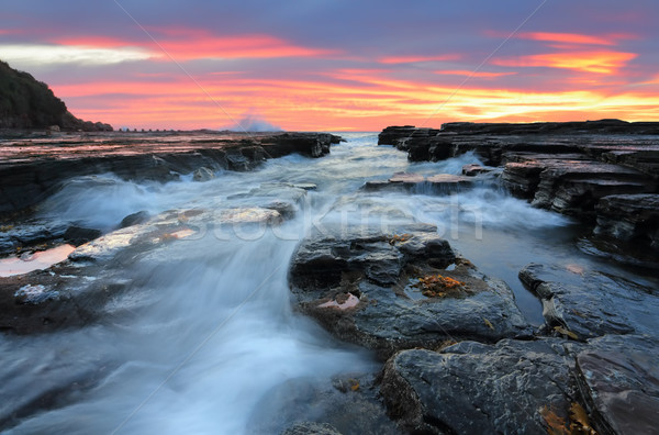 Sunrise waves flowing into rock chasm seascape Stock photo © lovleah