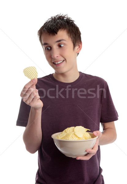 Boy holding potato crisp and smiling Stock photo © lovleah