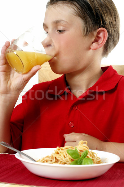 Szomjas gyermek iszik narancslé műanyag csésze Stock fotó © lovleah