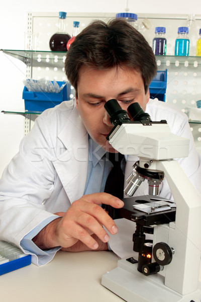 Scientist looking through microscope Stock photo © lovleah