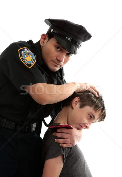 Police officer apprehending a teenage thief Stock photo © lovleah