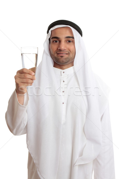 Happy arab man holding a glass of fresh drinking water Stock photo © lovleah