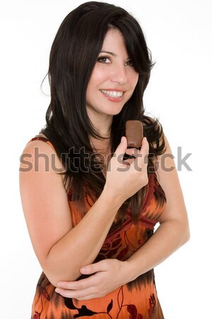 Vonzó nő eszik csokoládé falatozó csinos barna hajú Stock fotó © lovleah
