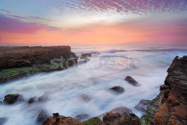 Stunning sunrise and ocean flows over tidal rocks Stock photo © lovleah