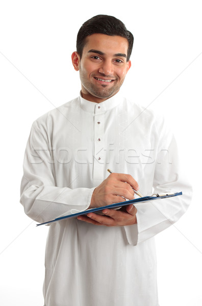 Smiling businessman writing in folder Stock photo © lovleah