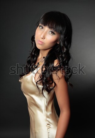 Beautiful woman in gold dress Stock photo © lovleah