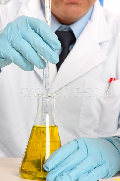 Scientist stirring liquid in flask Stock photo © lovleah