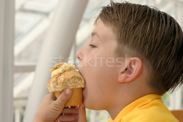 Stock photo: Boy eating a banana muffin