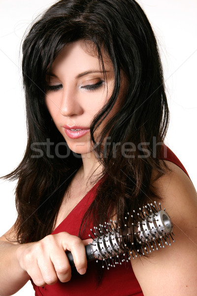 Beautiful woman brushing her hair Stock photo © lovleah