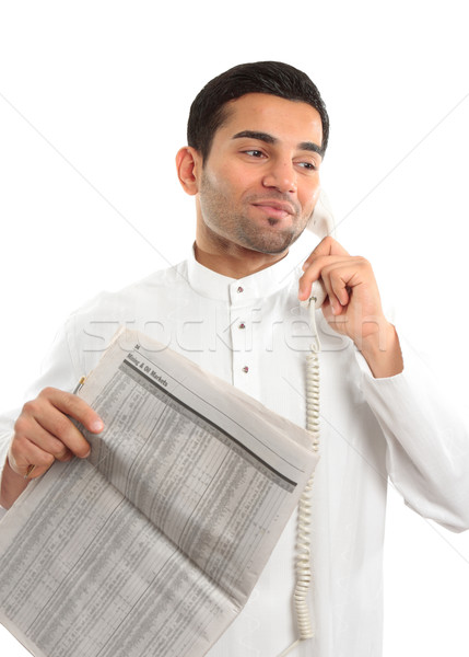 Stockbroker or Businessman on phone holding newspaper Stock photo © lovleah