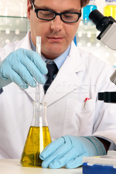 Scientist mixing liquids chemicals Stock photo © lovleah