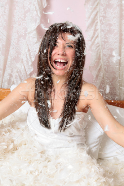 Woman playing with feather and down Stock photo © lovleah