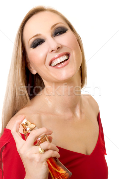 Beautiful smiling woman with bottle of perfume Stock photo © lovleah