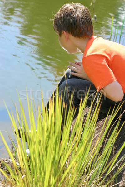 Boy sitting by the lake Stock photo © lovleah