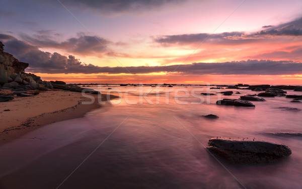 Magnificent sunrise high tide at Bateau Bay rockshelf Stock photo © lovleah