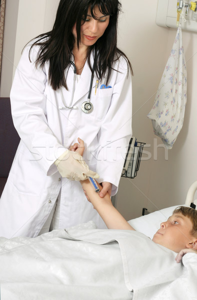 Doctor nurse caring for a young patient Stock photo © lovleah