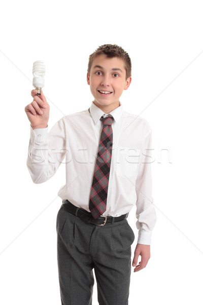 Stock photo: School boy holding a light bulb