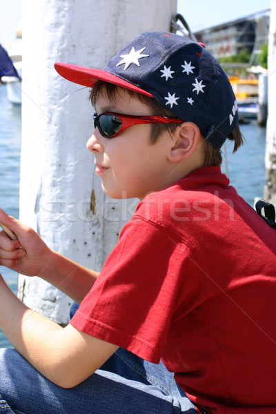 Child sitting on jetty wharf Stock photo © lovleah