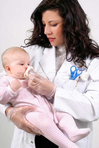Beautiful doctor medicating baby Stock photo © lovleah