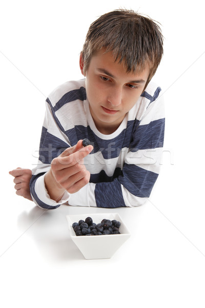 Stock photo: Boy inspecting blueberry