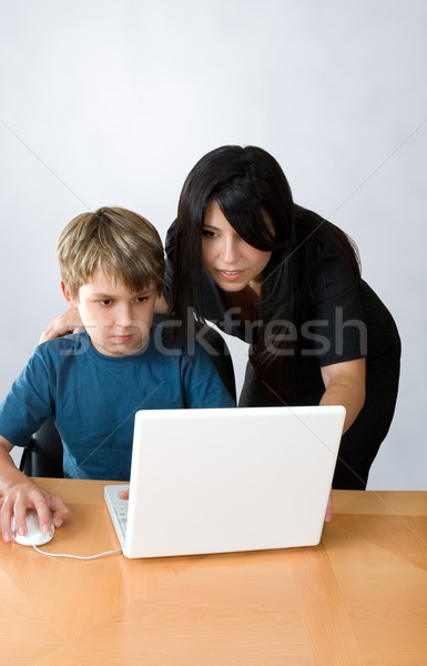 Adult assisting child on computer Stock photo © lovleah