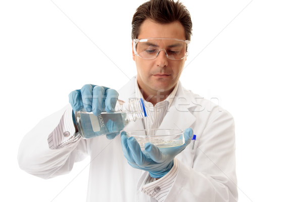 Scientist pouring liquid into petri dish Stock photo © lovleah