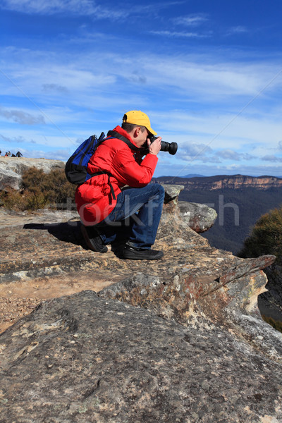 Photographer taking photos of mountain landscape Stock photo © lovleah