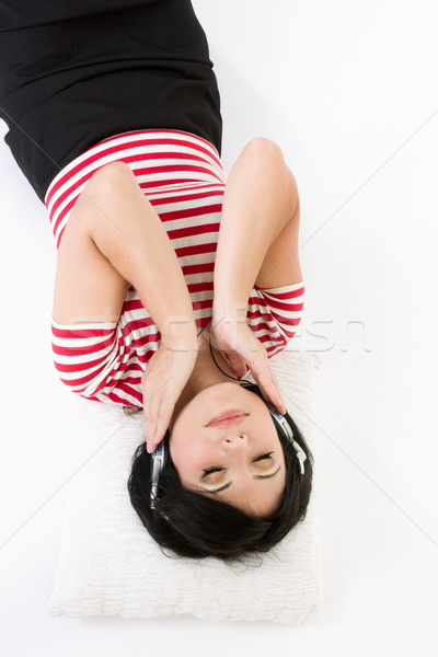 Woman laying down listening to music Stock photo © lovleah