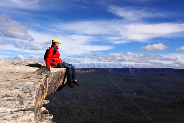 Sitting on Top of the World - hiker rests and admires views of B Stock photo © lovleah