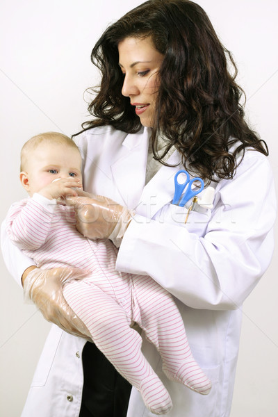 Caring doctor nurse treating a baby Stock photo © lovleah