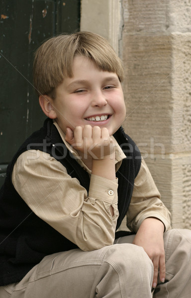 Smiling boy sitting on doorstep Stock photo © lovleah