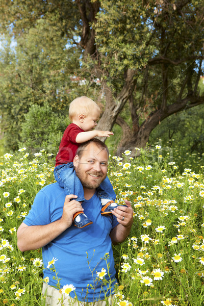 father and son in flowers Stock photo © lubavnel