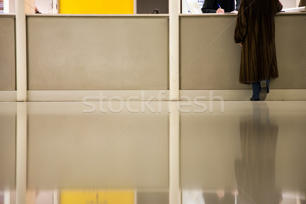 woman at info desk in airport Stock photo © lubavnel