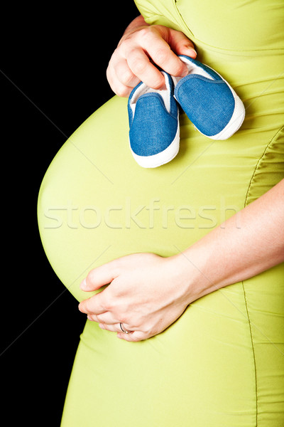 pregnant woman with baby shoes Stock photo © lubavnel