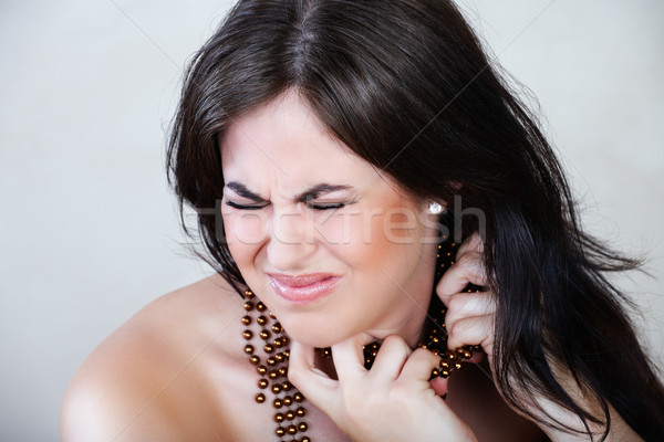 Angry woman with beads. Stock photo © lubavnel