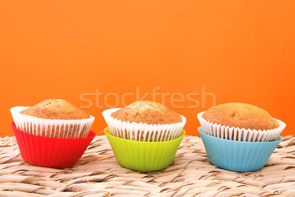 Three vanilla muffins in plastic cups Stock photo © lubavnel