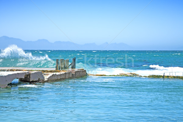óceán hullámok törött móló napos idő western Stock fotó © lubavnel