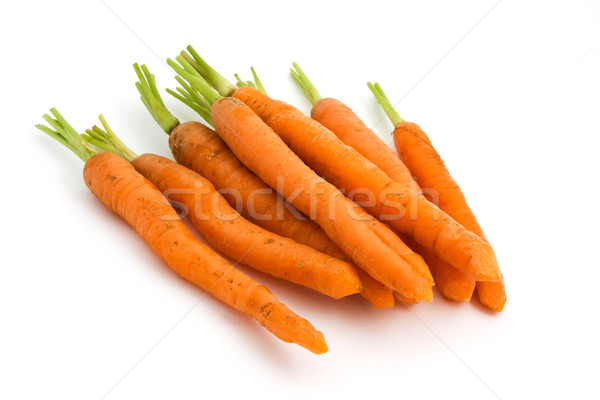 Pile of organic carrots with green tops over white Stock photo © lucielang