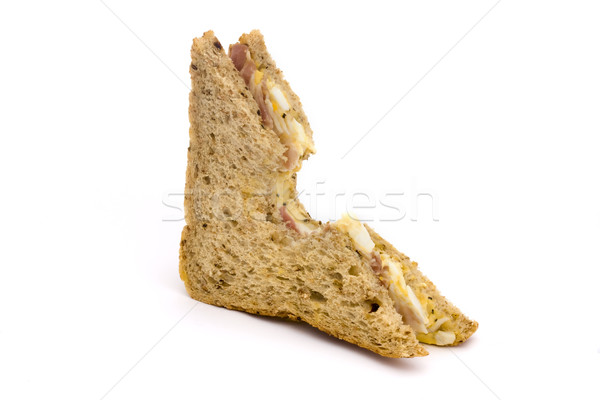 Half an egg and bacon sandwhich with a bite taken Stock photo © lucielang