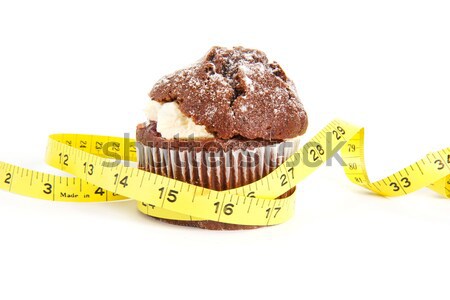 Chocolate muffin with a tape measure around it on white Stock photo © lucielang