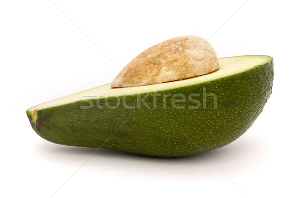 Stock photo: Half an avocado with stone isolated on white