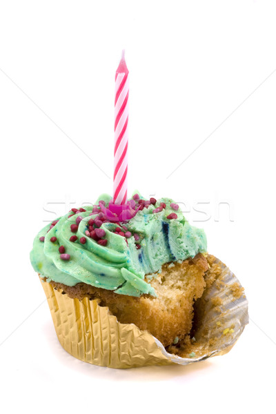 Green cupcake with candle and bite taken over white Stock photo © lucielang