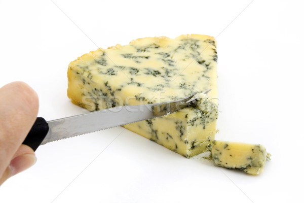 Wedge of blue cheese being cut over white Stock photo © lucielang