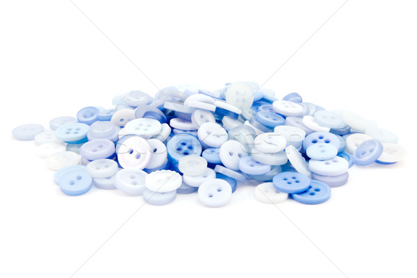 Stock photo: Pile of blue buttons over white