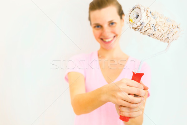 Young Happy Woman with roller brush. Stock photo © luckyraccoon