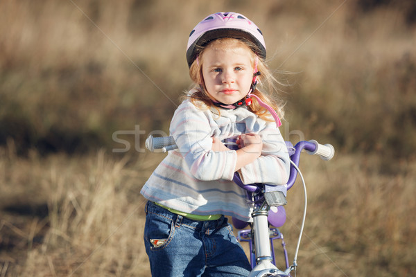 Small funny kid riding bike with training wheels. Stock photo © luckyraccoon