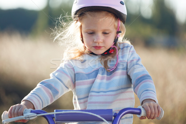 Small funny kid riding bike with training wheels. Stock photo © luckyraccoon