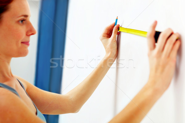 Portrait of young woman with measuring tape. Stock photo © luckyraccoon